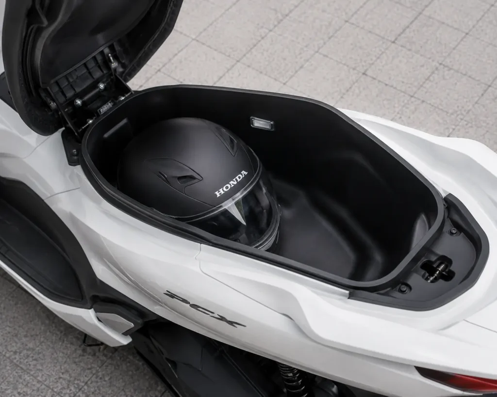 Honda PCX 125 large under-seat storage compartment with helmet