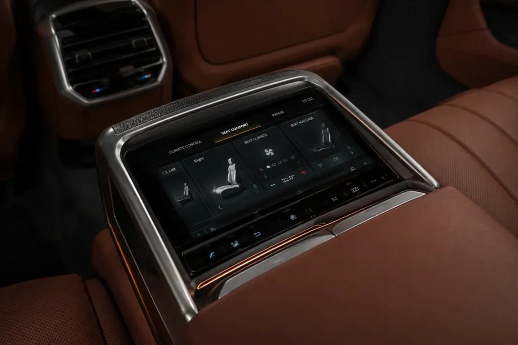 BMW i7 rear passenger touchscreen controls integrated into door panel.