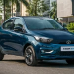 2026 Tata Tigor EV compact electric sedan parked on a city street.