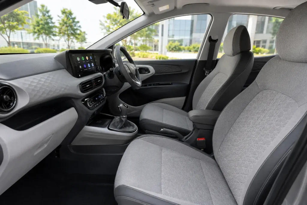Hyundai Aura front seats with premium upholstery, automatic climate control, and ergonomic cockpit layout